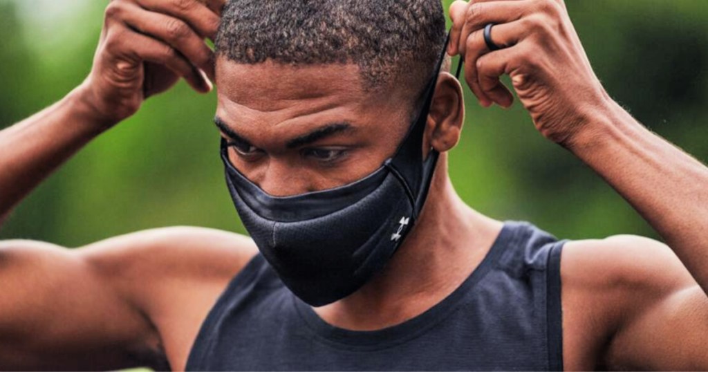 man putting on a UA SportsMask