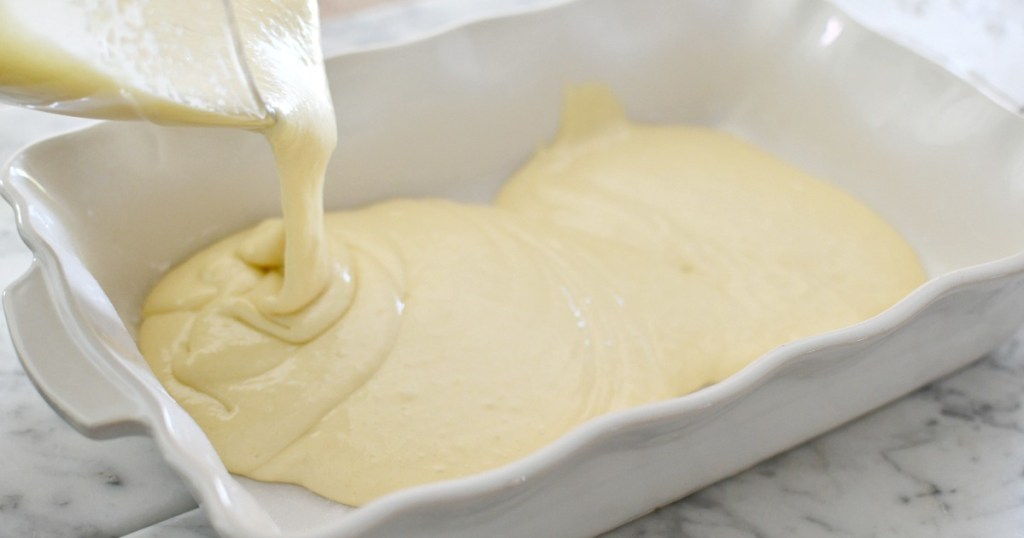 pouring cake batter in a pan