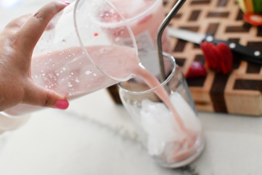 pouring beverage from a blender to a cup