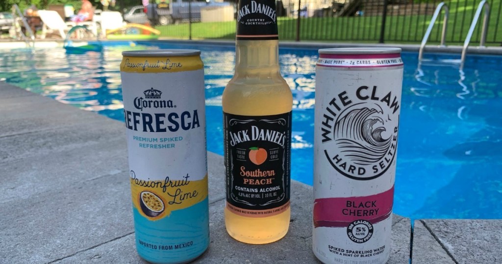 adult summer cocktails sitting by pool 