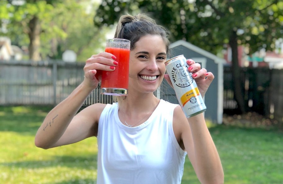 woman holding up white claw