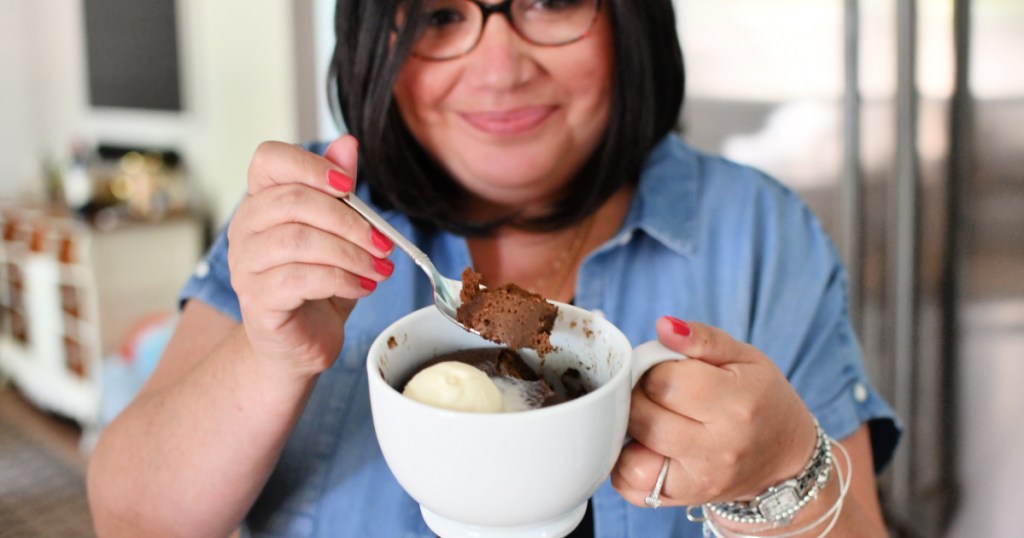 woman holding a nutella mug cake