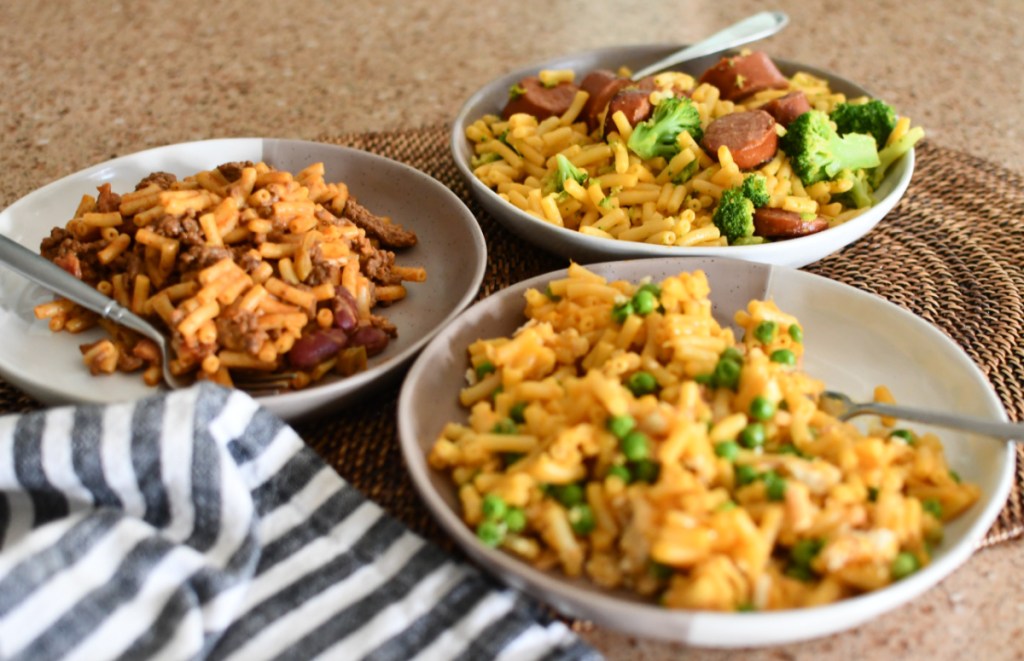 3 plates of mac and cheese with different toppings