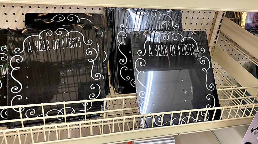 A Year of Firsts chalkboard signs on shelf at Dollar Tree