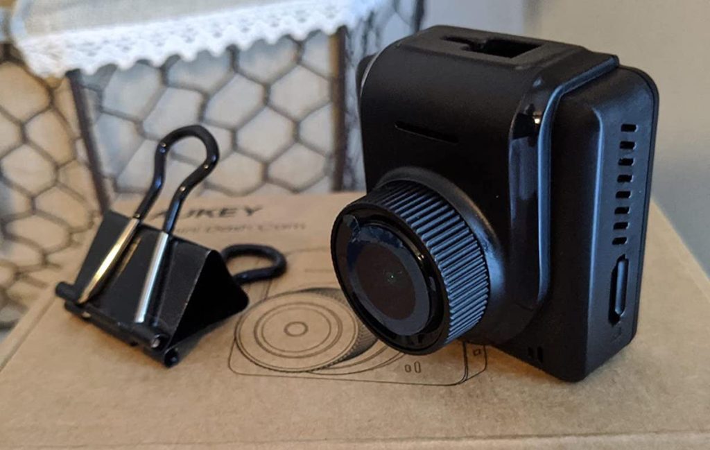 mini camera next to paper clip