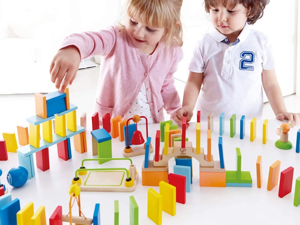 hape dynamo wooden domino set two kids playing
