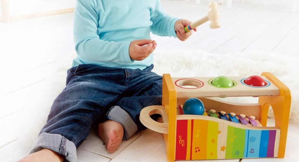 hape pound and tap bench with little boy sitting