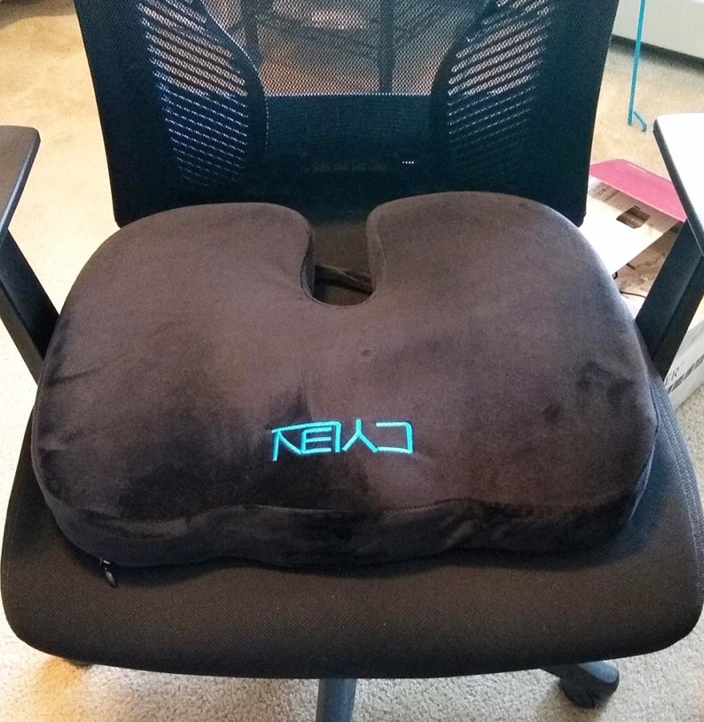 black mesh office chair with a black memory foam seat cushion on it