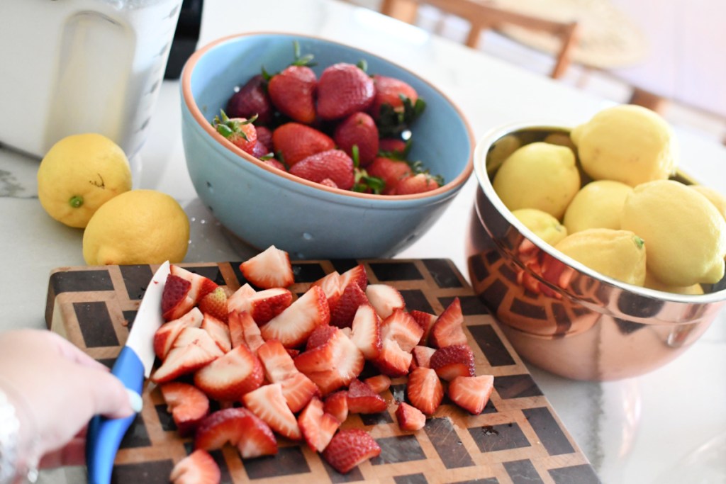 Chopping Strawberries on a wood cutting board