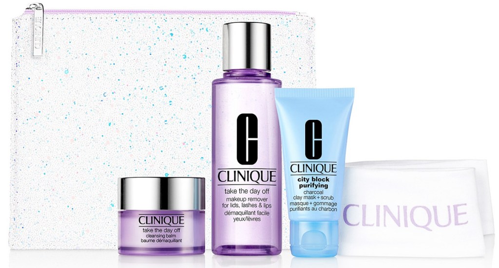three clinique skincare products with white clinique headband and sparkly cosmetics bag