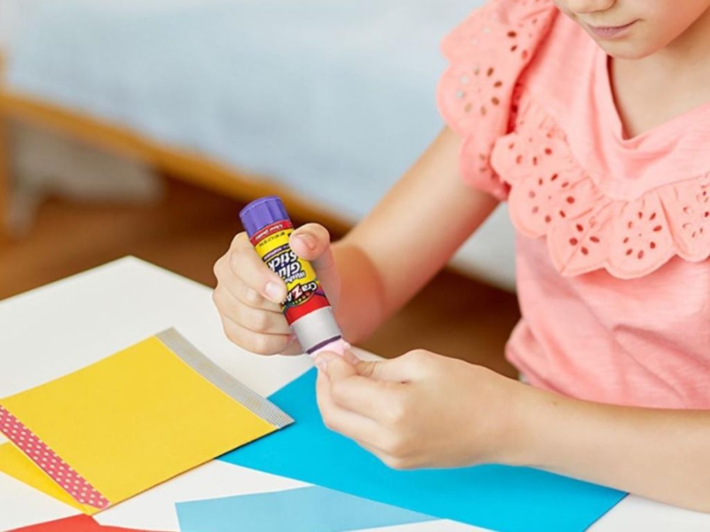 girl using glue stick