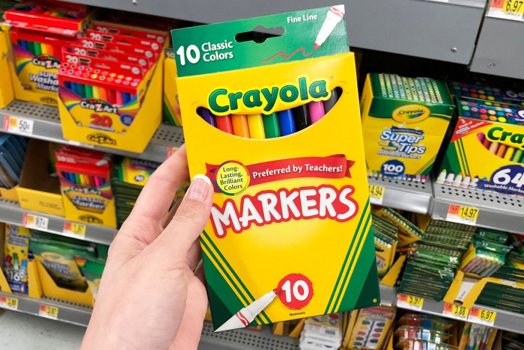 person holding up yellow box of crayola fine line markers