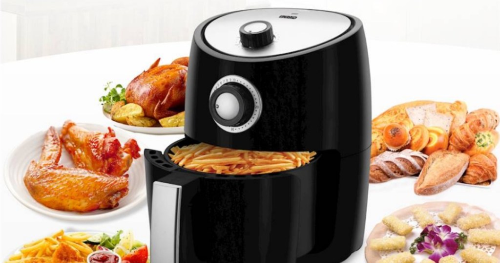 black air fryer surrounded by fried foods