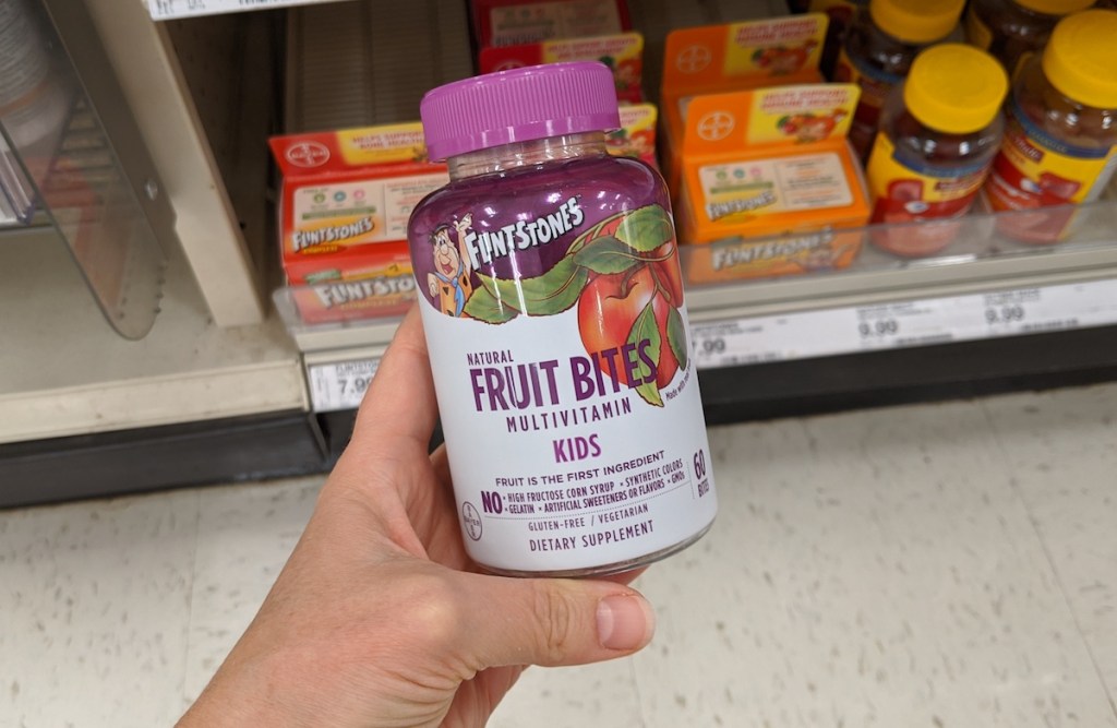 hand holding bottle of Flinstones Fruit Bites