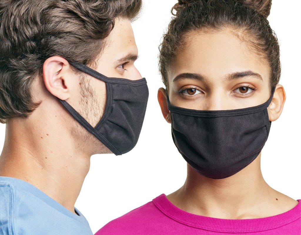 man in light blue shirt and woman in pink shirt both wearing matching black face masks