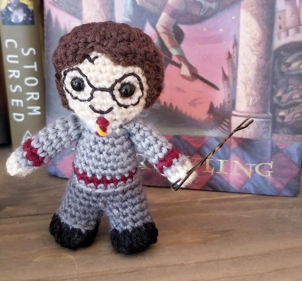 crochet harry potter doll next to harry potter book