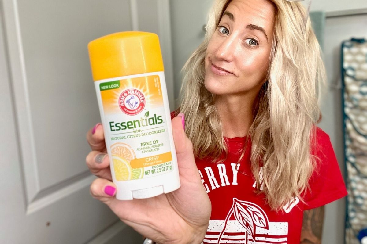 A woman holding natural deodorant