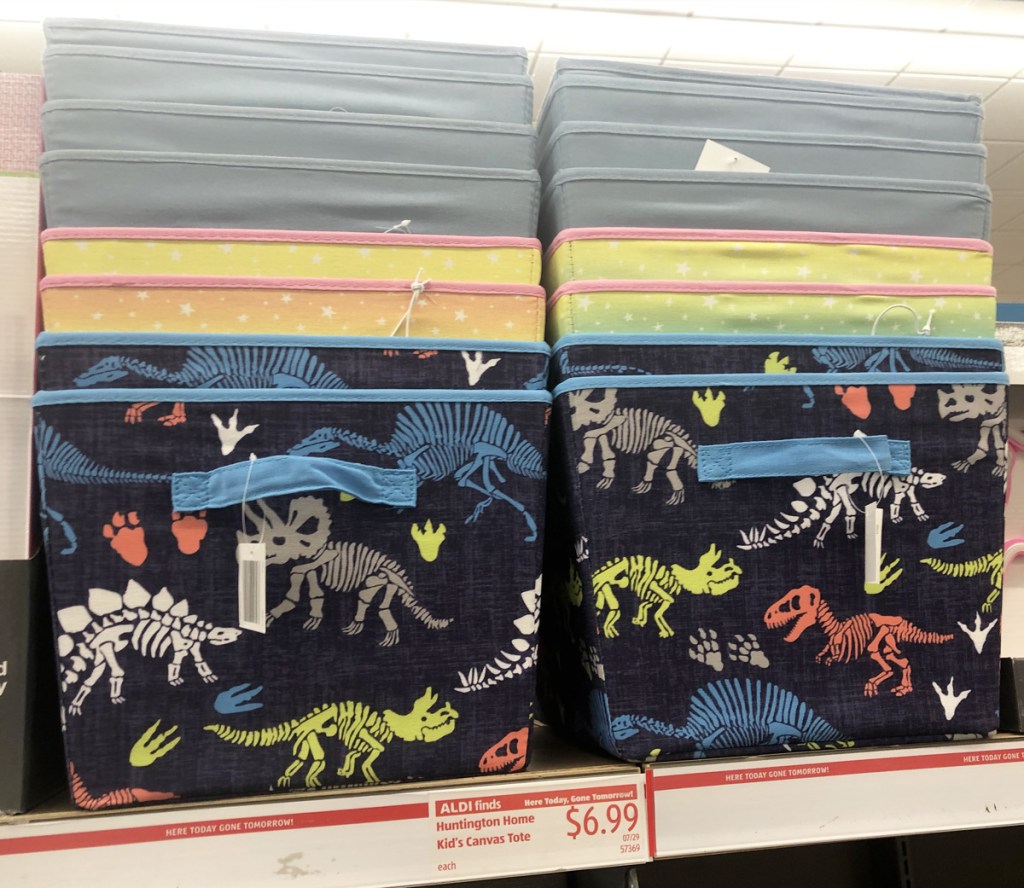 two stacks of kids canvas storage totes in dinosaur print, star print, and solid grey