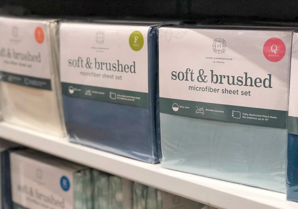 plastic packages of microfiber sheet sets on store display shelf