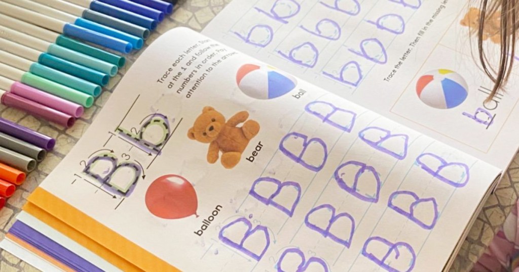 child's learn to write workbook filled in tracing the letter B in purple marker