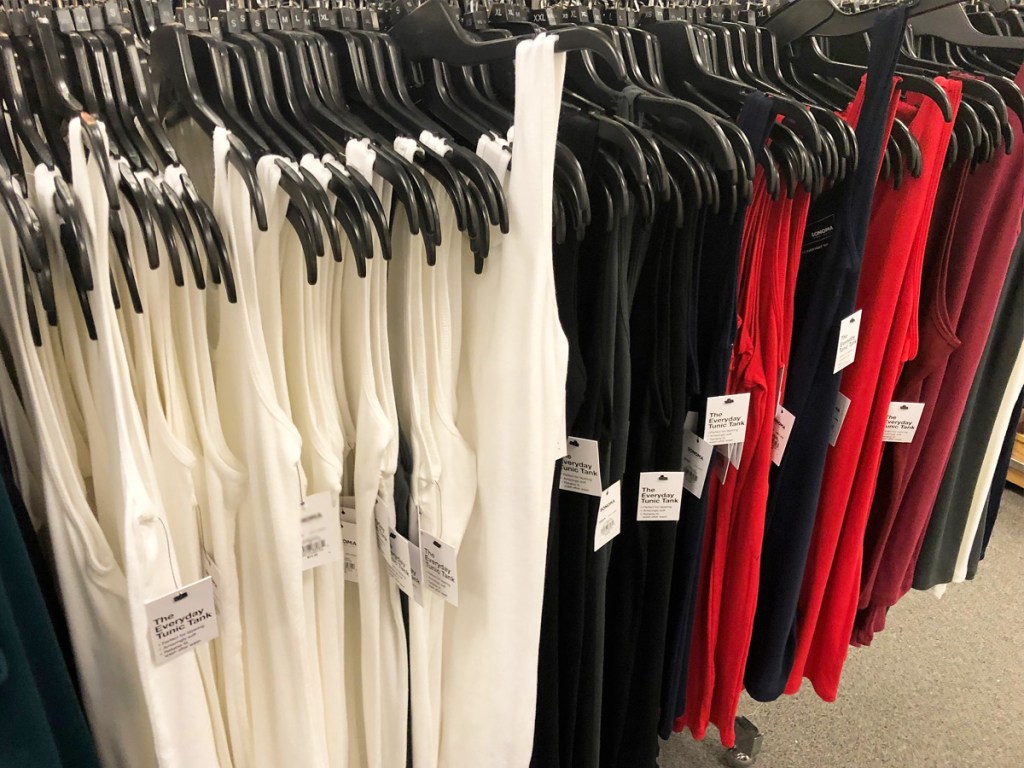 womens basic tank tops hanging on black hangers on store display rack