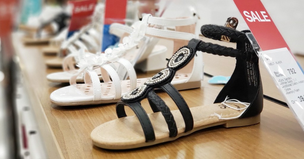 store display of girls gladiator sandals in black and white colors