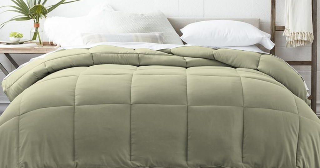 Moss Green Down alternative comforter on a bed with white fluffy pillows