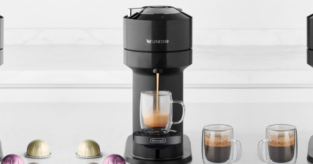 nespresso veruo next coffee maker on counter with cup of coffee being brewed and cup of coffee next to it