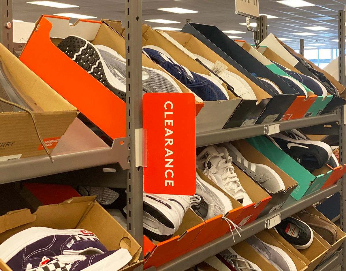 clearance rack full of boxes of boys sneakers