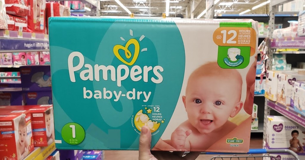 hand holding box of newborn diapers in store