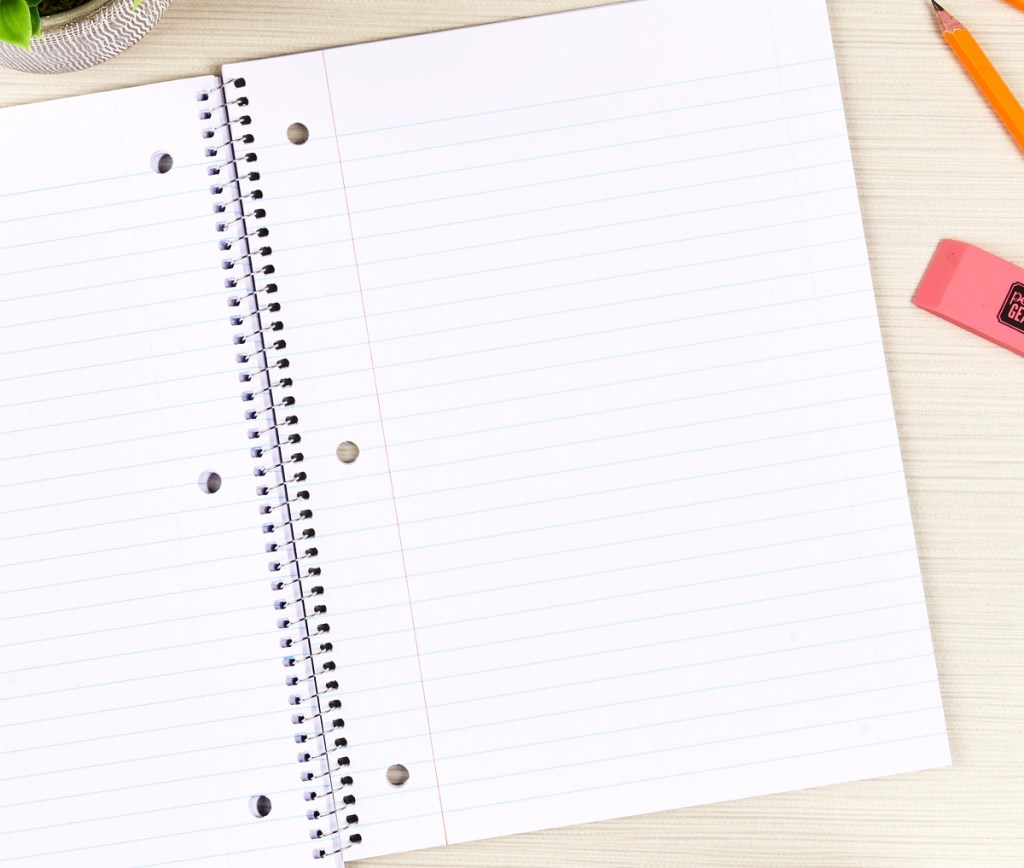 opened sprial notebook on table with pencil and pink eraser next to it