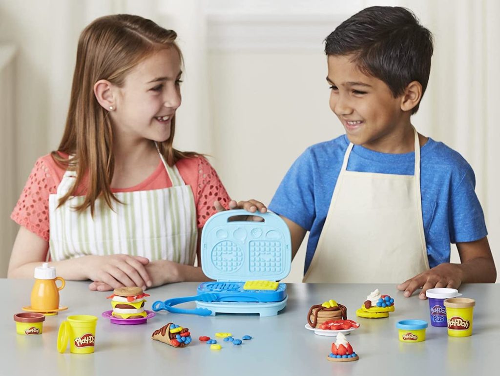 kids playing with a Play-Doh Bakery set