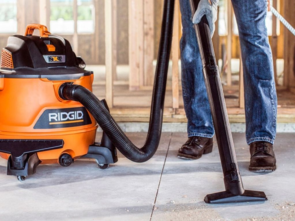 man using shop vacuum