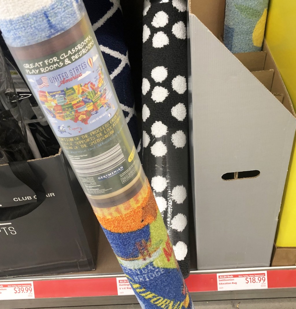 rolled up map of the United States kids rug on a store shelf with other rolled rugs