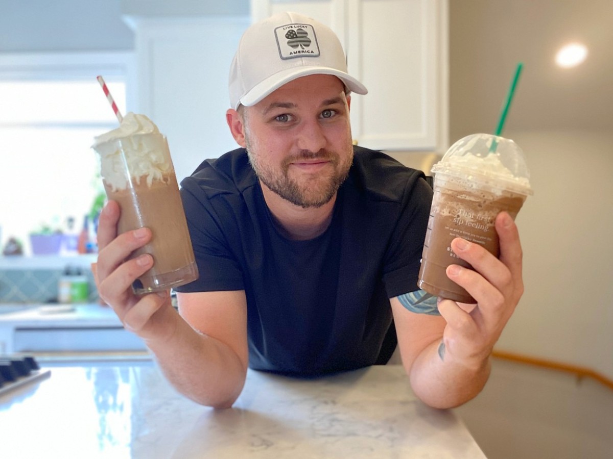 man holding Starbucks frappuccino and dupe in each hand