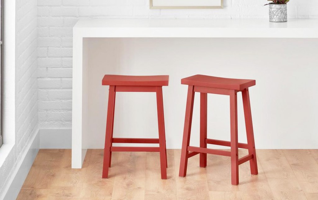 two red saddle style backless barstools