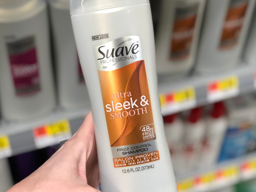 hand holding suave shampoo in-store at walmart 