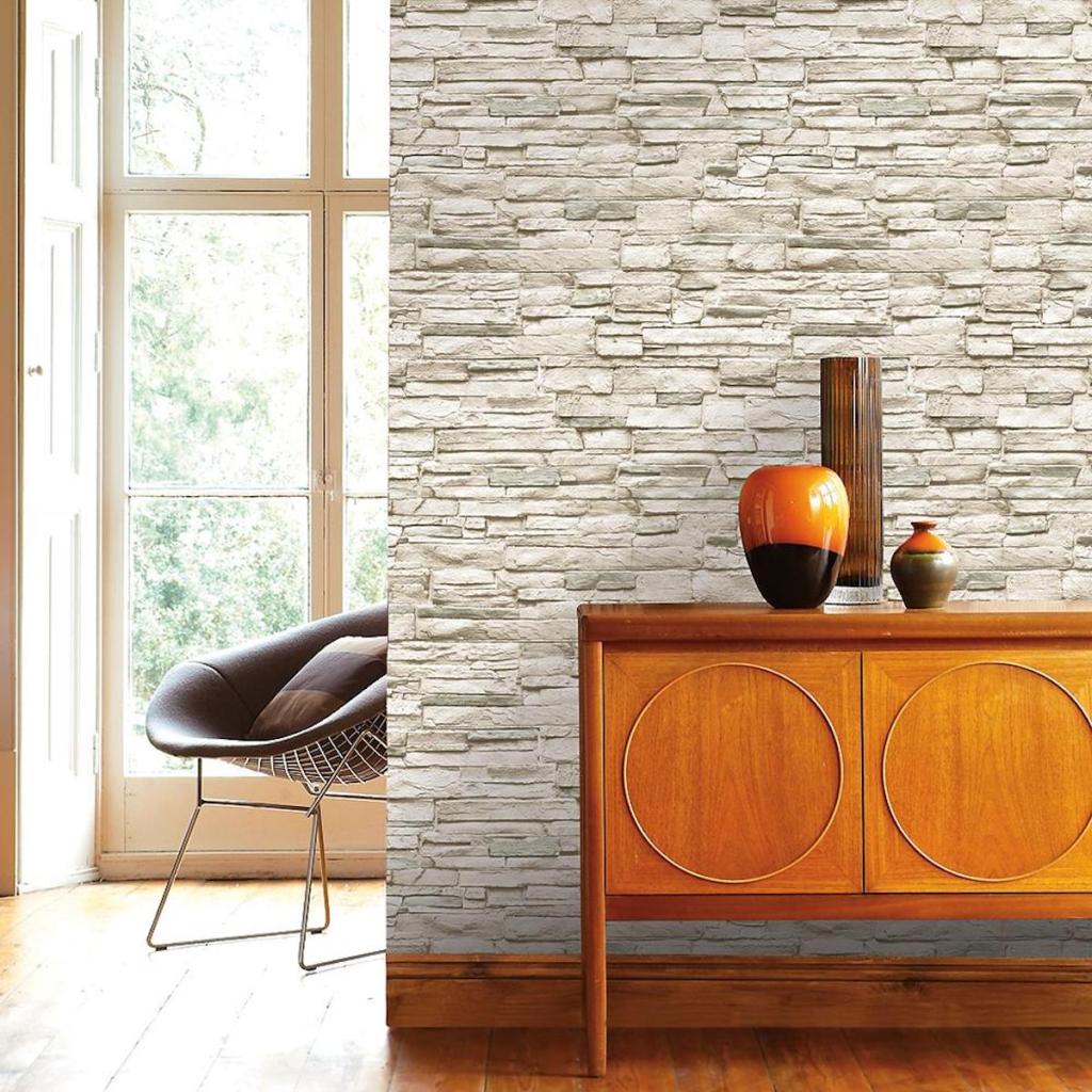 Tempaper Light Stone Ivory Peel and Stick Wallpaper on accent wall with wood wall table with decorative pieces on the table