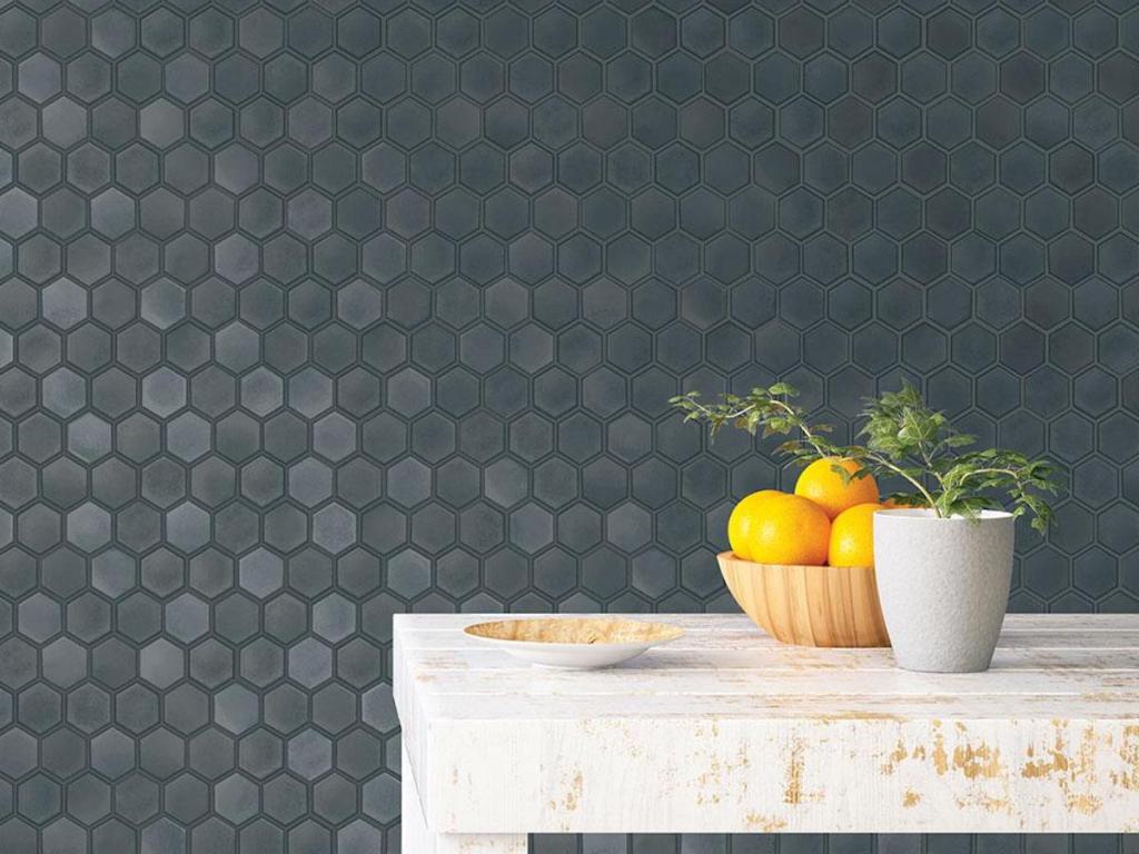 dark colored Tempaper Hexagon Tiles Gunmetal Peel and Stick Wallpaper on wall with wood farmhouse like table with bowl of lemons