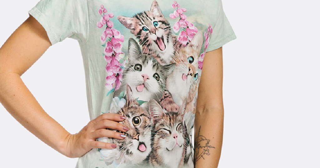 woman standing with a hand on her hip wearing a t-shirt with kittens