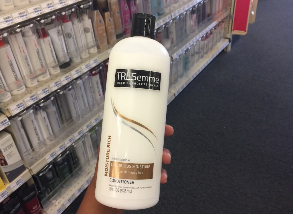 hand holding bottle of Tresemme Conditioner