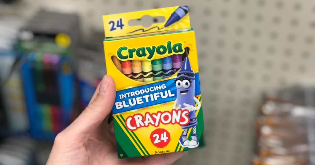 hand holding box of 24 count crayola crayons in store