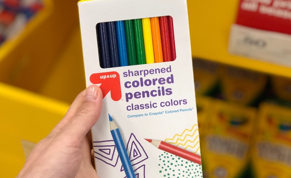 hand holding package of colored pencils