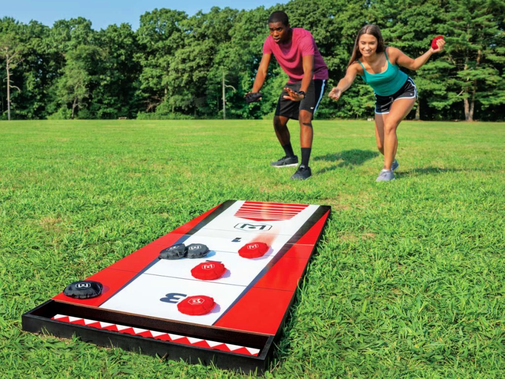 man and woman playing Wicked Big Sports Shuffle Toss