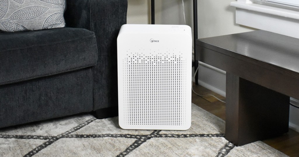 white rectangular air purifier on area rug near couch in living room