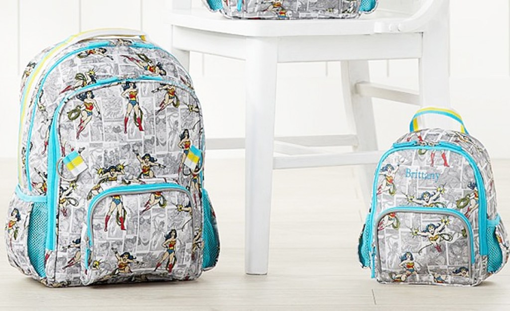 large and mini wonder woman print backpacks sitting on floor