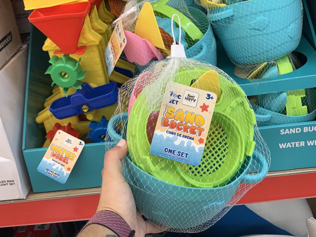 hand holding up sand bucket at ALDI