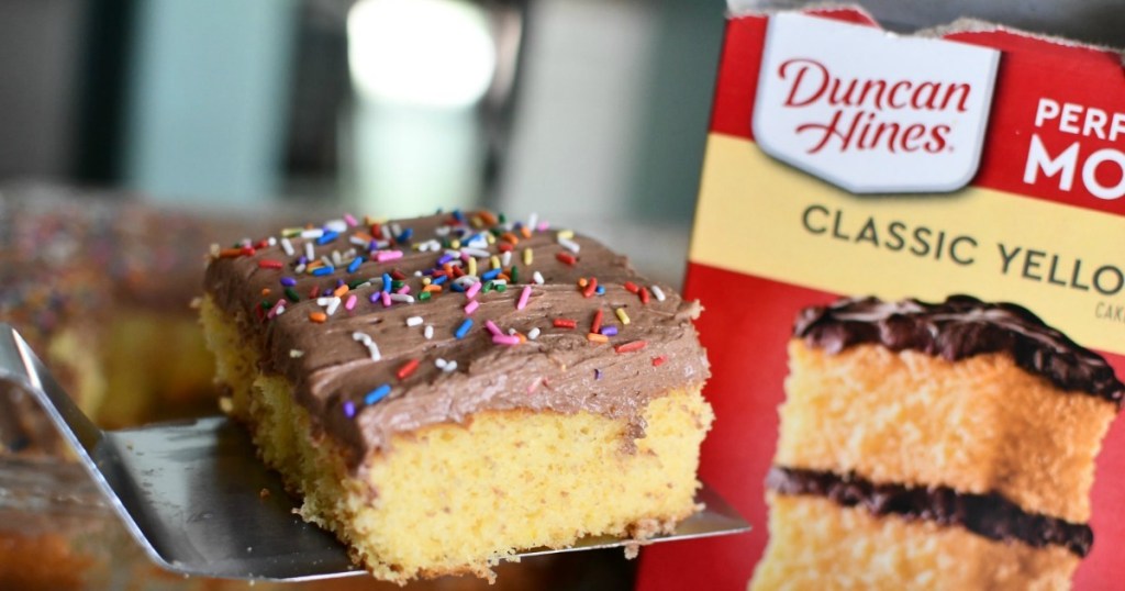 slice of yellow cake with chocolate frosting and duncan hines box