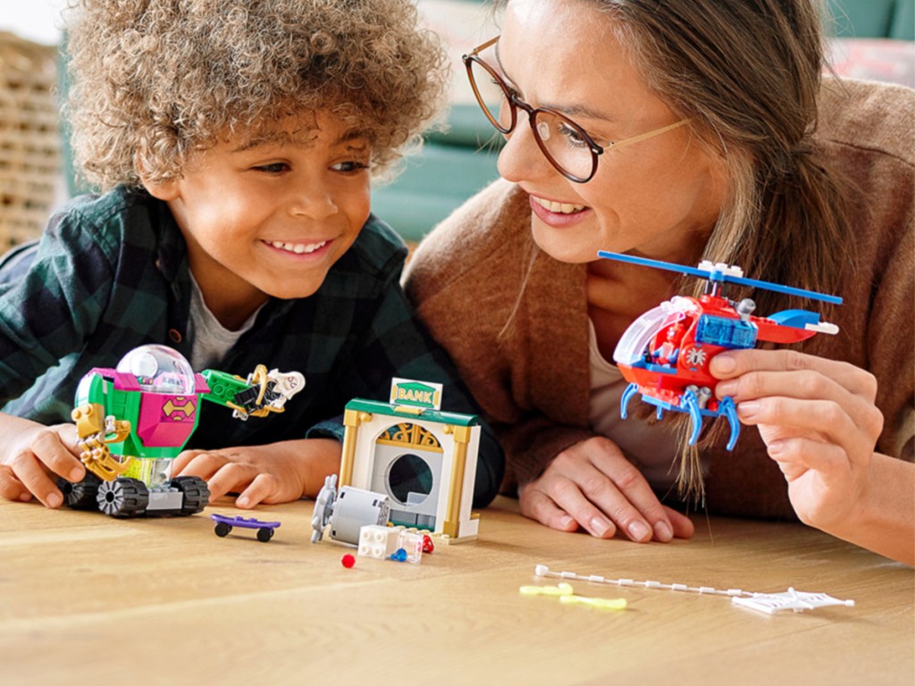 child and mother playing with a LEGO Marvel Spider-Man The Menace of Mysterio Superhero Building Set