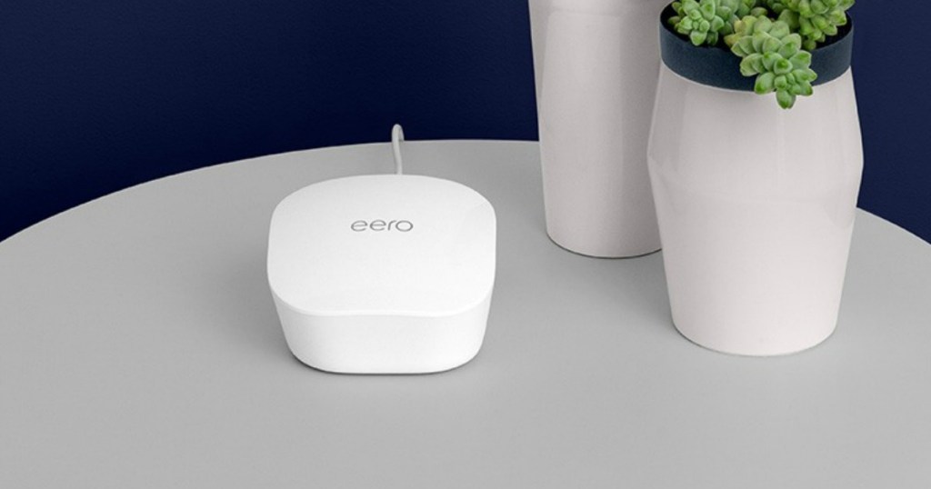 eero router on table by vases